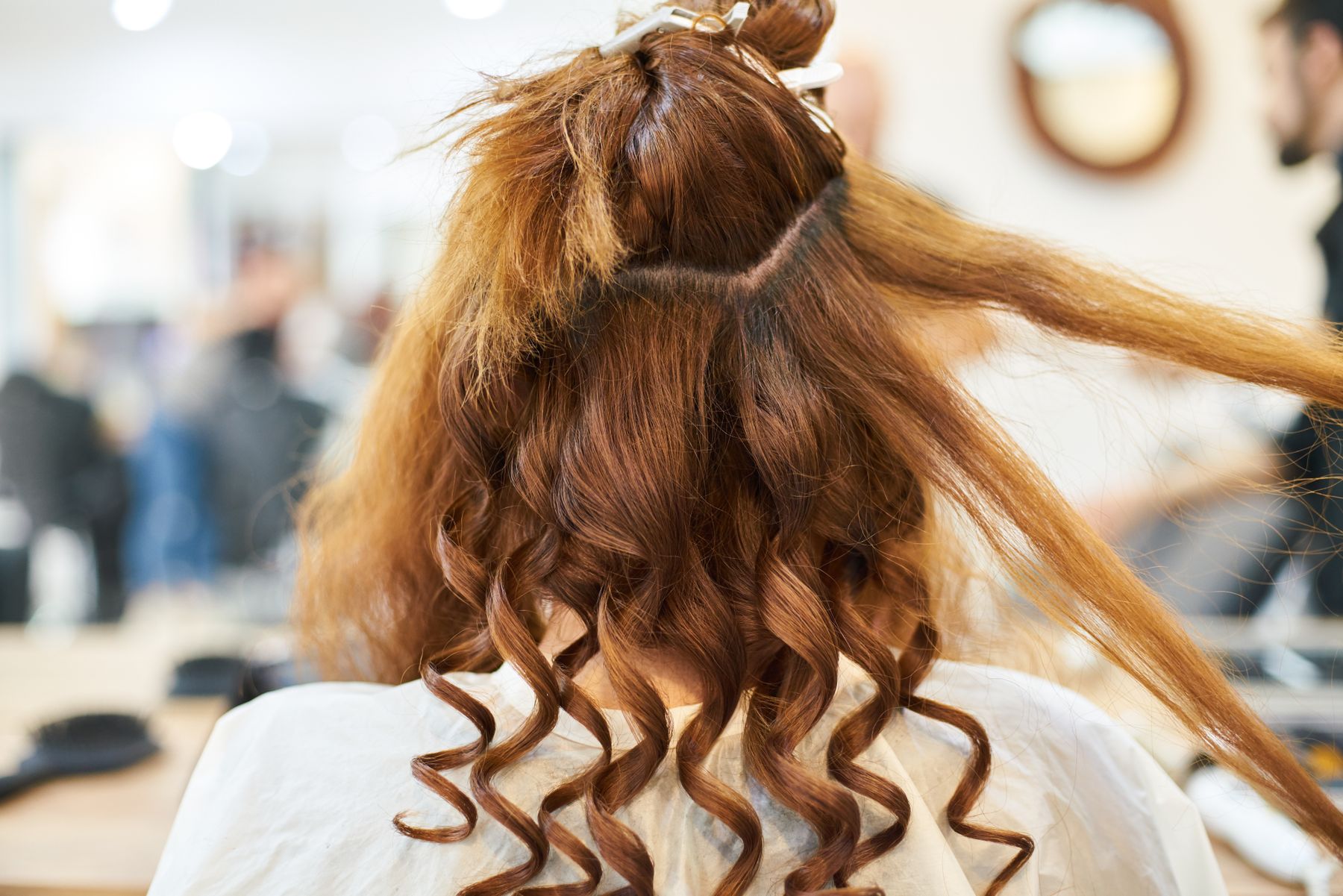 Stylist finishing long curled hair