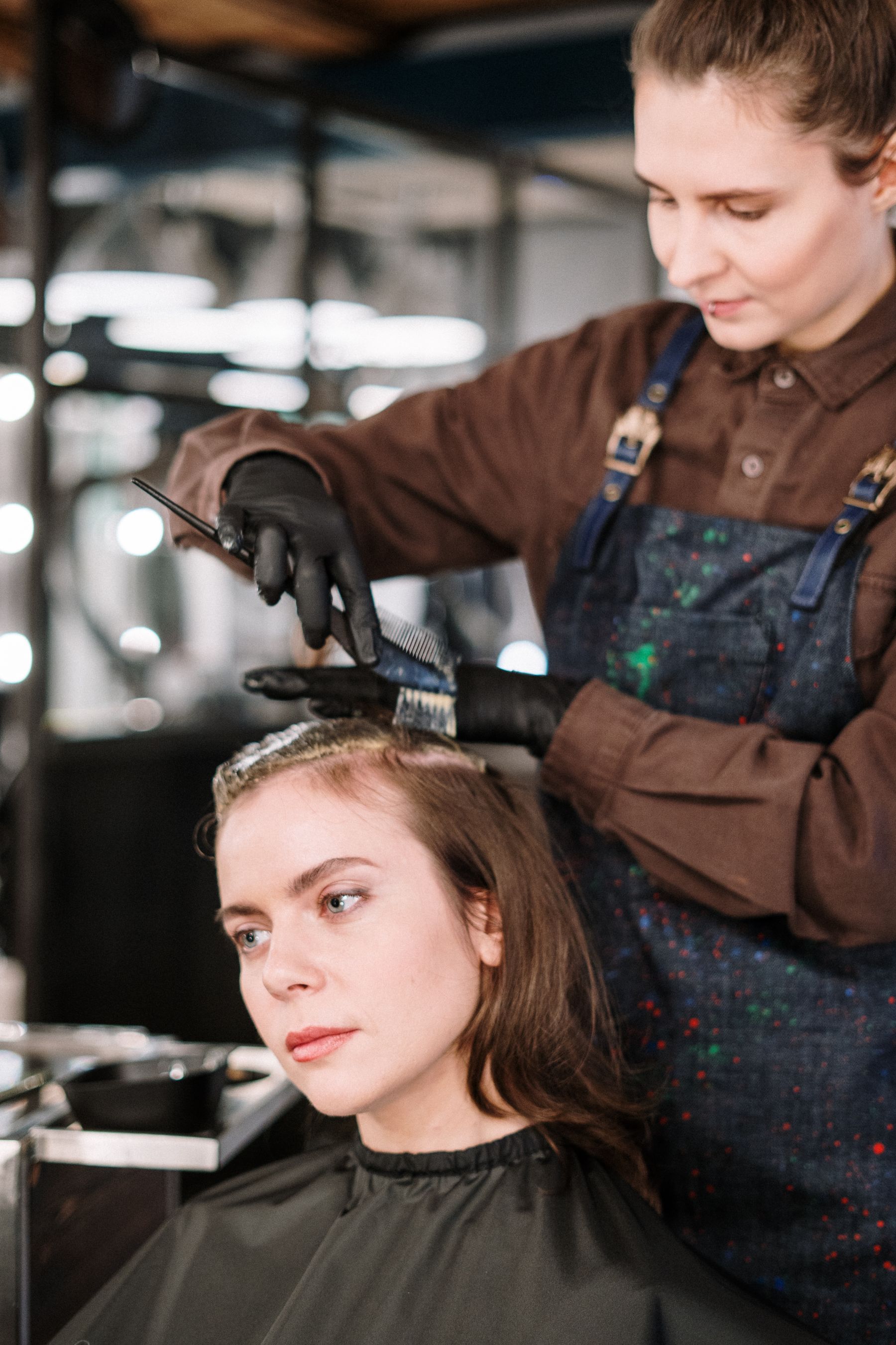 Hairdresser cutting a woman's hair in the salon chair