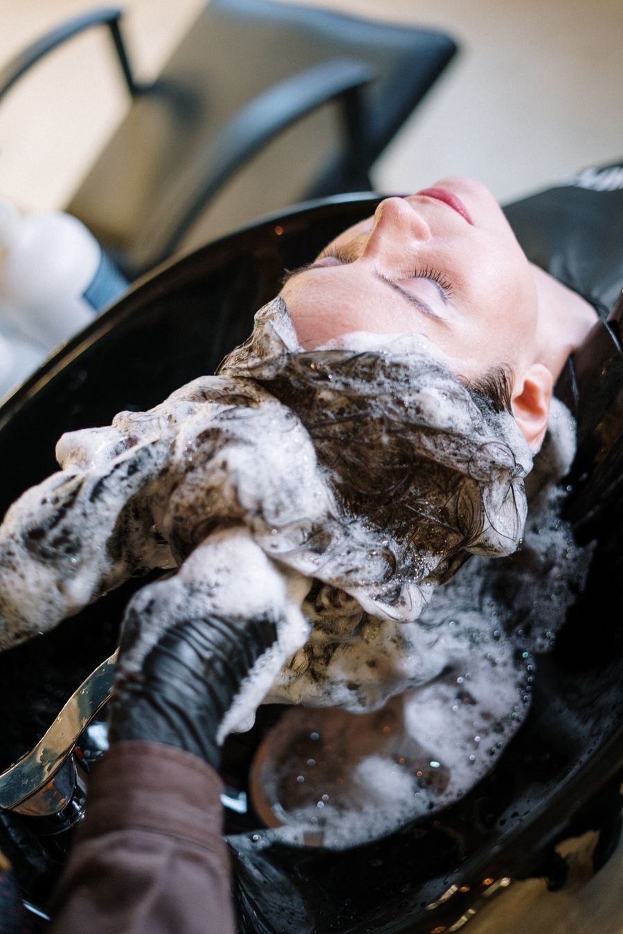 Client relaxing at the basin during a treatment